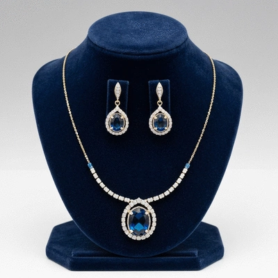 Elegant blue gemstone necklace and earrings on a velvet display