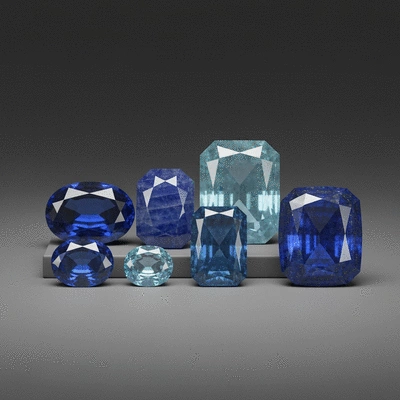Assortment of polished blue gemstones like sapphire, aquamarine, and lapis lazuli on a neutral background