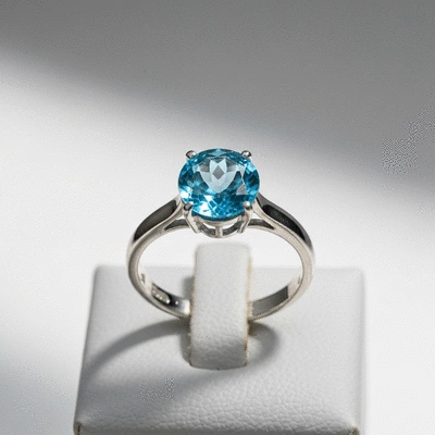 Elegant blue topaz ring on a display stand
