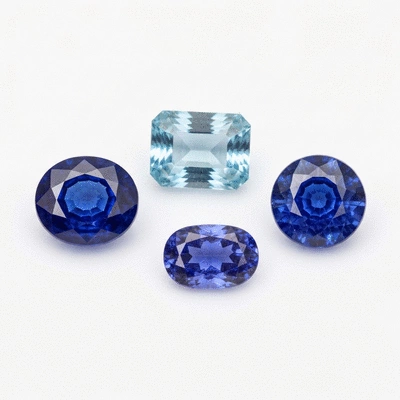 Assortment of blue gemstones, including sapphire and aquamarine, showcasing varying color intensities