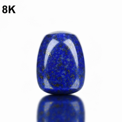 Close-up of a deep blue lapis lazuli gemstone, polished and reflecting light