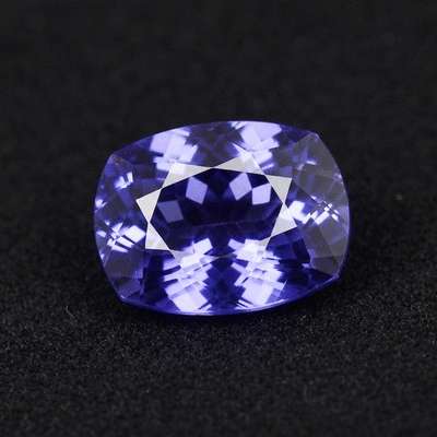 Close-up of various blue gemstones on a soft, elegant fabric, clean image