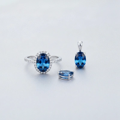 Elegant blue gemstone ring and pendant on a soft background