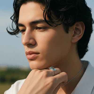 Person wearing blue topaz jewelry