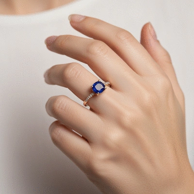 Elegant sapphire engagement ring on a female hand, showcasing fine jewelry craftsmanship