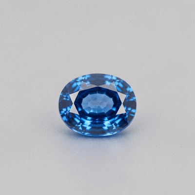 Close-up of a vibrant blue sapphire gemstone, sparkling under natural light
